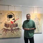 Jeff Del Nero with his paintings